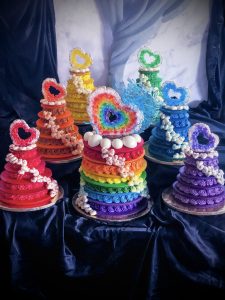 Tiered rainbow macaron cake ensemble